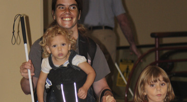 Pamela, a blind mom, smiles with her two daughters.